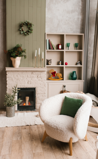 Image of a cozy room with a chair and a fireplace