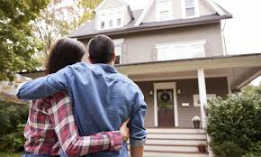 Couple hugging as they have just bought a new house- Buying a house in the uk comprehensive guide